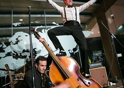 Man with a flaming trumpet standing on a double bass