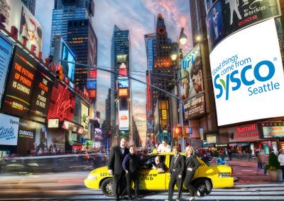 six people posing on a taxi in Times Square New York City